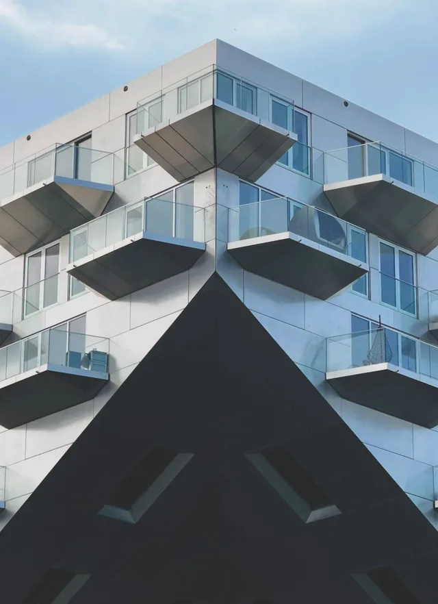 Illustrative white apartment building with projecting glass balconies